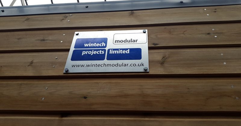 Modular building with logo plaque